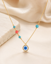Ojo oro con piedra turquesa y coral