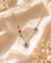 Ojo oro con piedra turquesa y coral